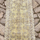 1970s yellow vintage Turkish floral runner rug with floral design, hand-knotted weave and low pile.