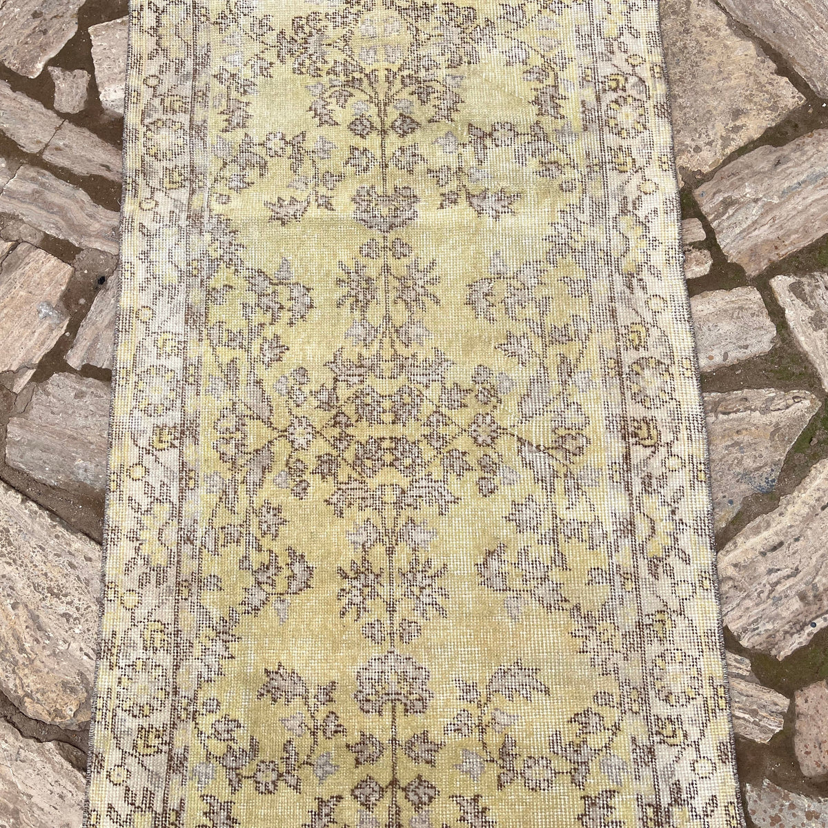 1970s yellow vintage Turkish floral runner rug with floral design, hand-knotted weave and low pile.