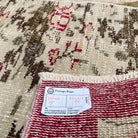 Close-up of the beige vintage Turkish floral runner rug showing traditional details, hand-knotted weave, wool and cotton and low pile.