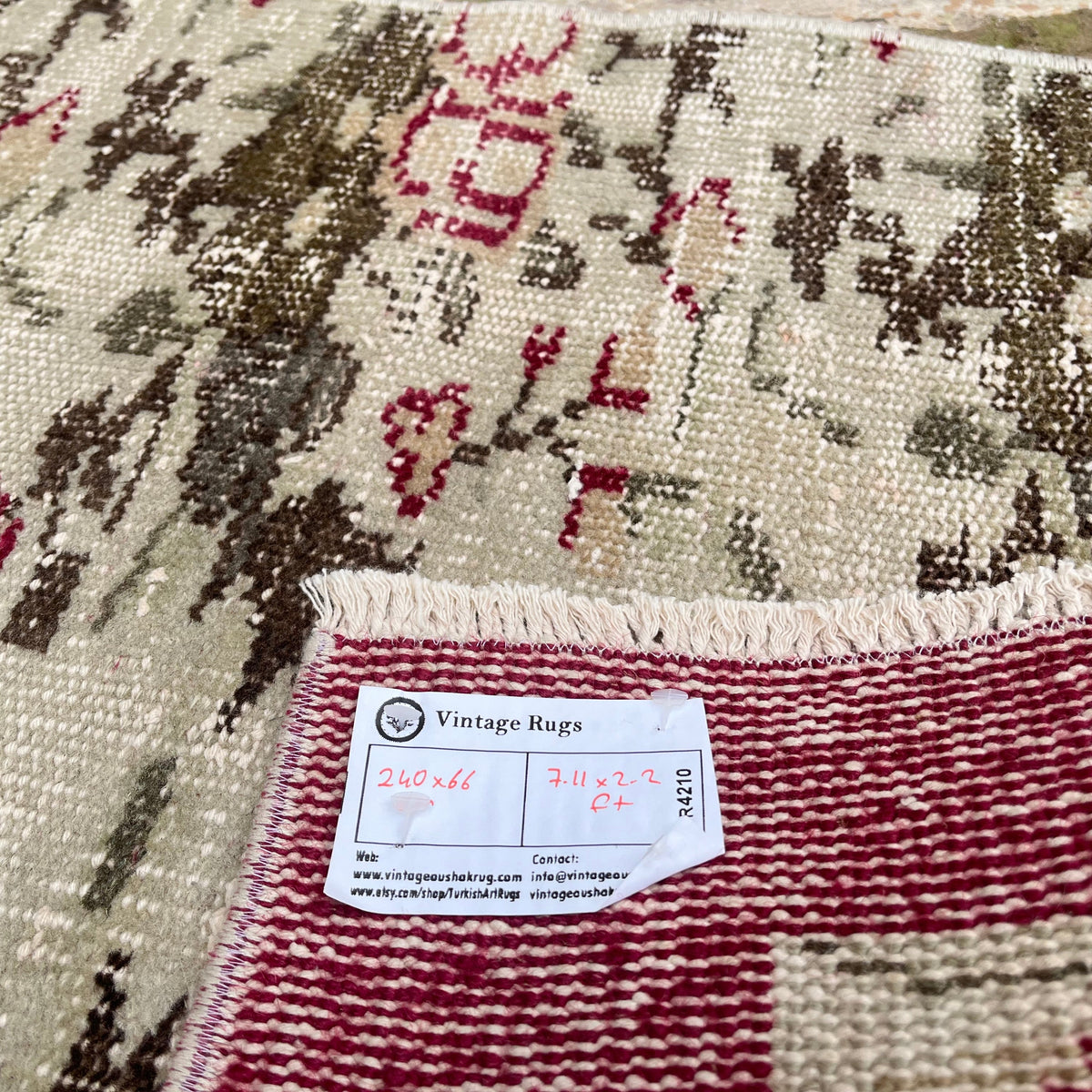 Close-up of the beige vintage Turkish floral runner rug showing traditional details, hand-knotted weave, wool and cotton and low pile.