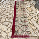 Beige 2' x 8' vintage Turkish floral runner rug in wool and cotton, shown on the floor.