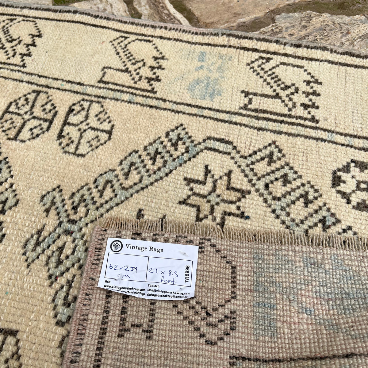 Close-up of the pale blue vintage Turkish floral runner rug showing traditional details, hand-knotted weave, wool and cotton and low pile.