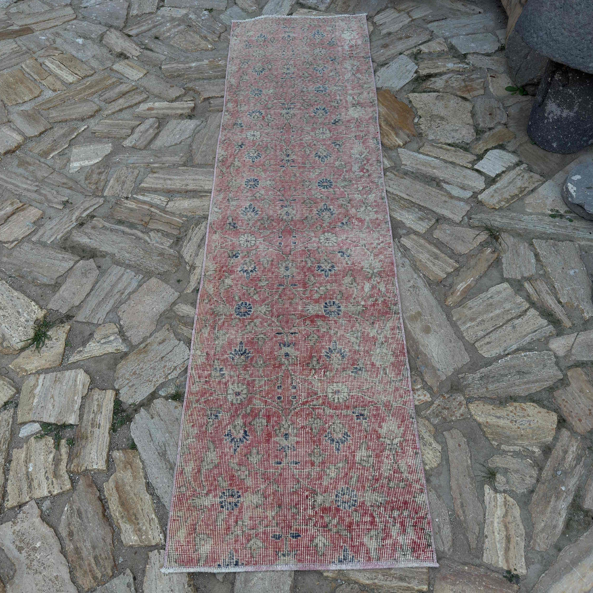 Pale Red 2' x 8' vintage Turkish floral runner rug in wool and cotton, shown on the floor.