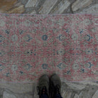 1970s pale red vintage Turkish floral runner rug with floral design, hand-knotted weave and low pile.