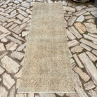 Beige 3' x 8' vintage Turkish floral runner rug in wool and cotton, shown on the floor.