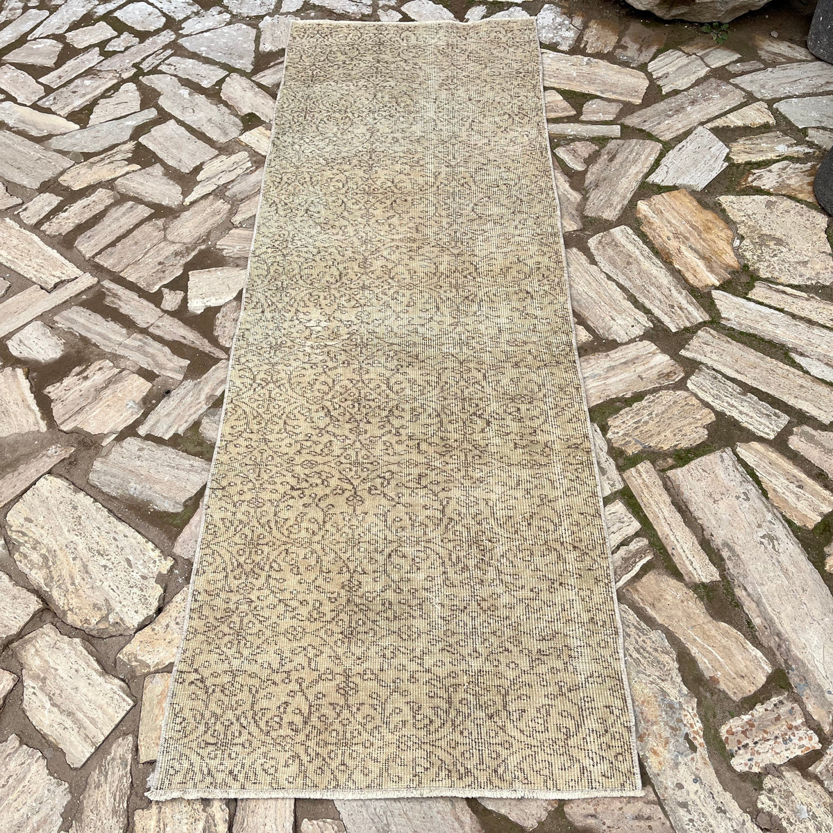 Beige 3' x 8' vintage Turkish floral runner rug in wool and cotton, shown on the floor.