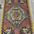 1970s pink vintage Turkish geometric carpet with traditional design, hand-knotted weave and low pile.