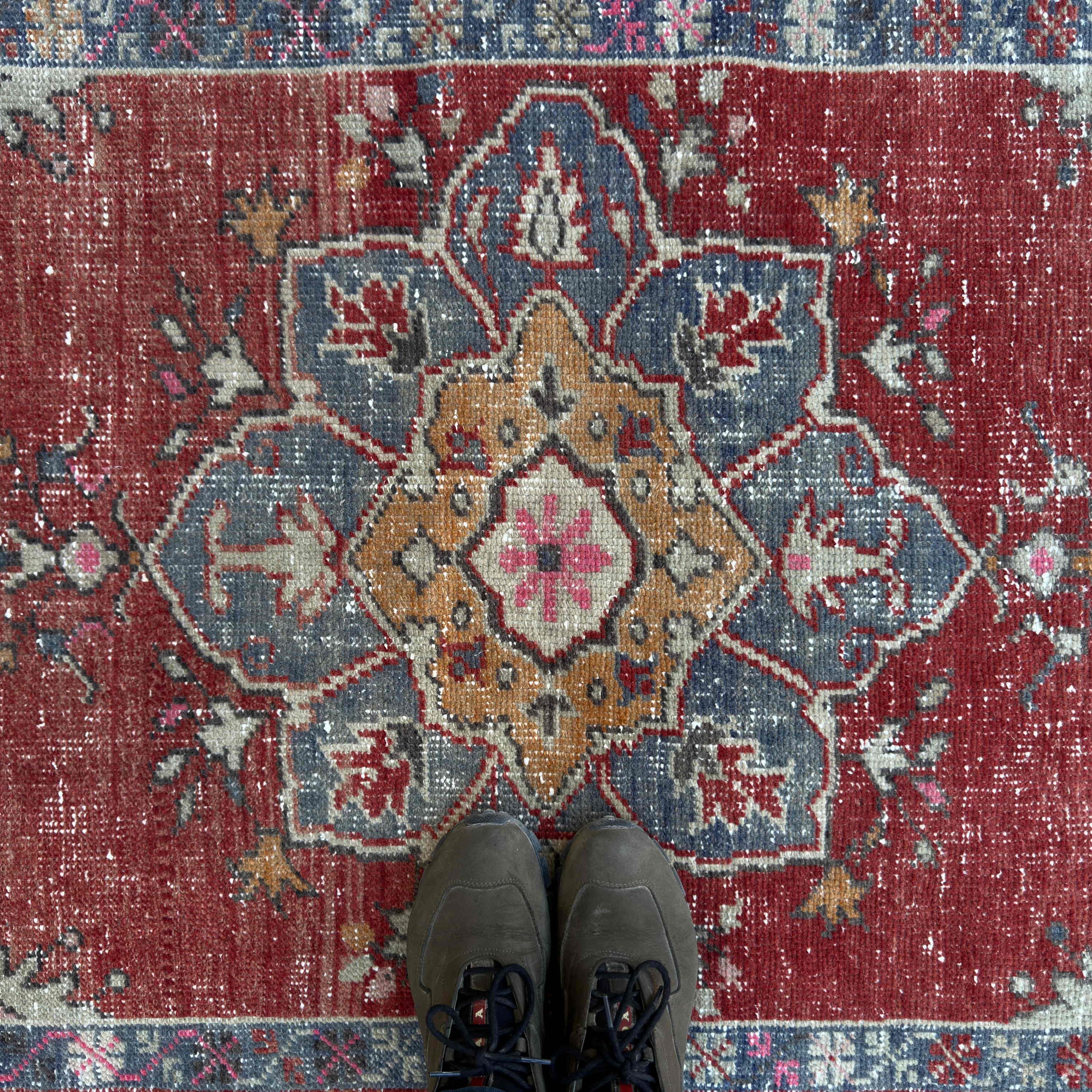 1970s red vintage Turkish geometric rug with traditional design, hand-knotted weave and low pile.
