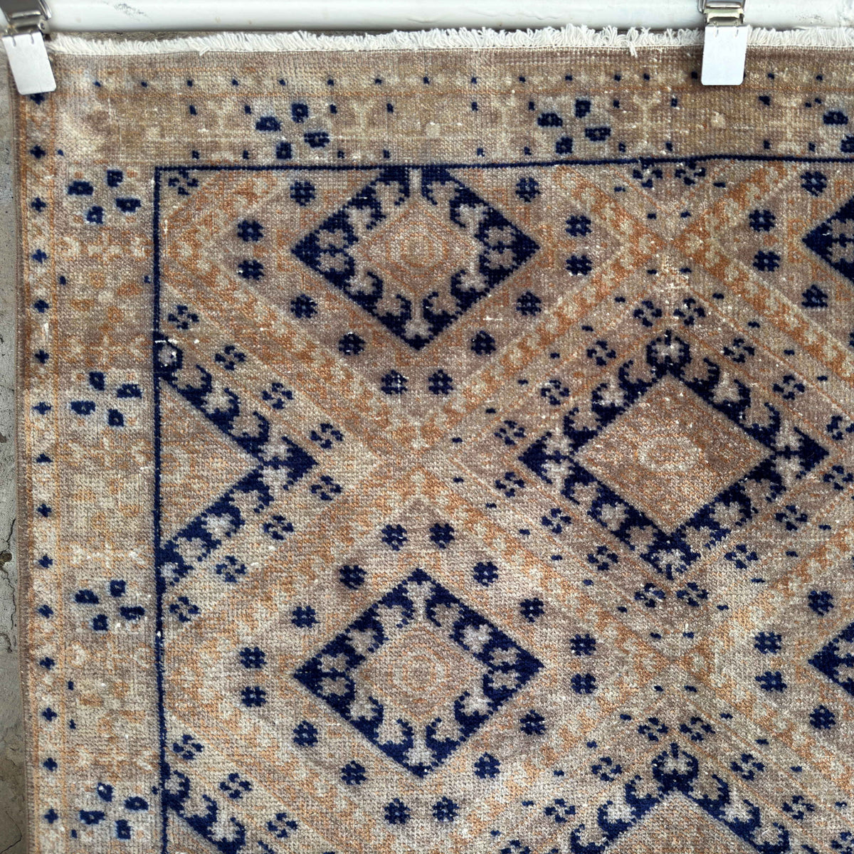 Close-up of the blue vintage geometric rug showing traditional details, hand-knotted weave, wool and cotton and low pile.