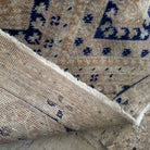 Blue 3' x 6' vintage geometric rug in wool and cotton, shown on the floor.