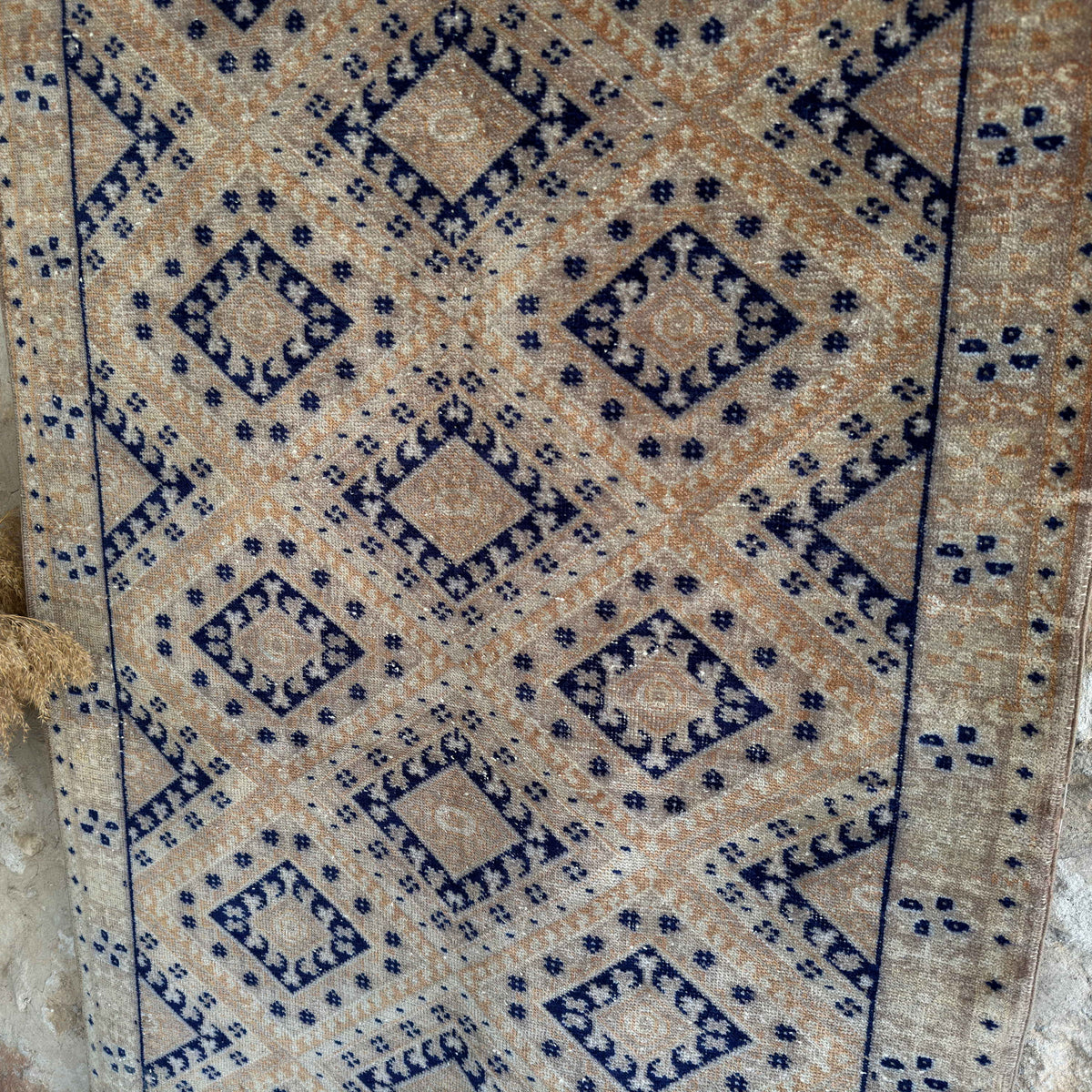 1970s blue vintage geometric rug with traditional design, hand-knotted weave and low pile.