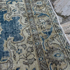 Close-up of the blue vintage Turkish geometric rug showing medallion details, hand-knotted weave, wool and cotton and low pile.
