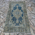 Blue 4' x 6' vintage Turkish geometric rug in wool and cotton, shown on the floor.