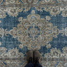 1970s blue vintage Turkish geometric rug with medallion design, hand-knotted weave and low pile.