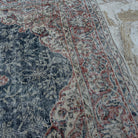 Close-up of the blue vintage Turkish geometric rug showing medallion details, hand-knotted weave, wool and cotton and low pile.