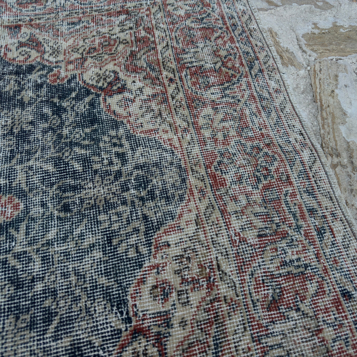 Close-up of the blue vintage Turkish geometric rug showing medallion details, hand-knotted weave, wool and cotton and low pile.