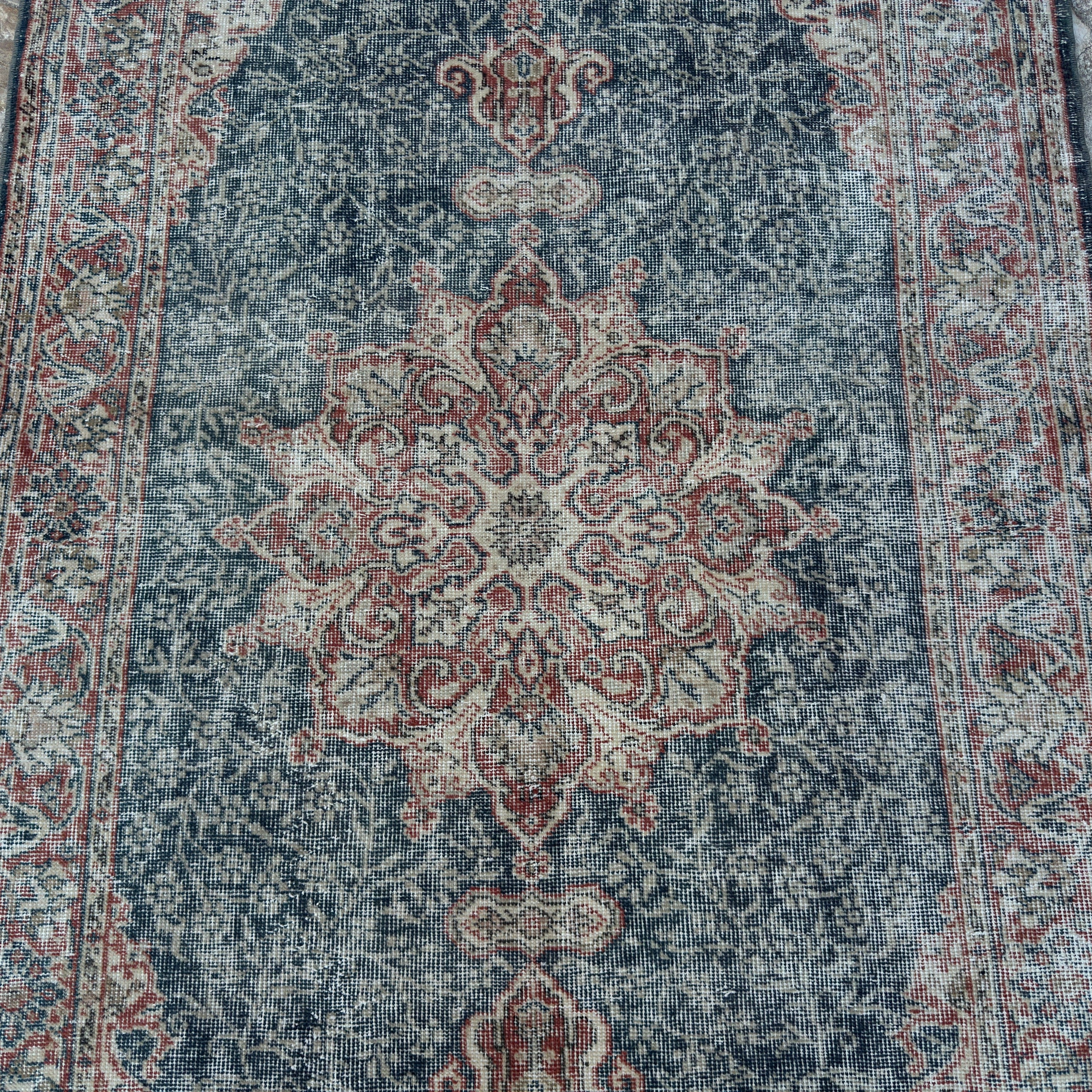 1970s blue vintage Turkish geometric rug with medallion design, hand-knotted weave and low pile.