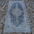 Blue 4' x 7' vintage Turkish geometric rug in wool and cotton, shown on the floor.