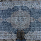 1970s blue vintage Turkish geometric rug with medallion design, hand-knotted weave and low pile.