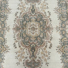 1970s pale green vintage Turkish geometric rug with medallion design, hand-knotted weave and low pile.