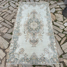 Pale Green 4' x 7' vintage Turkish geometric rug in wool and cotton, shown on the floor.