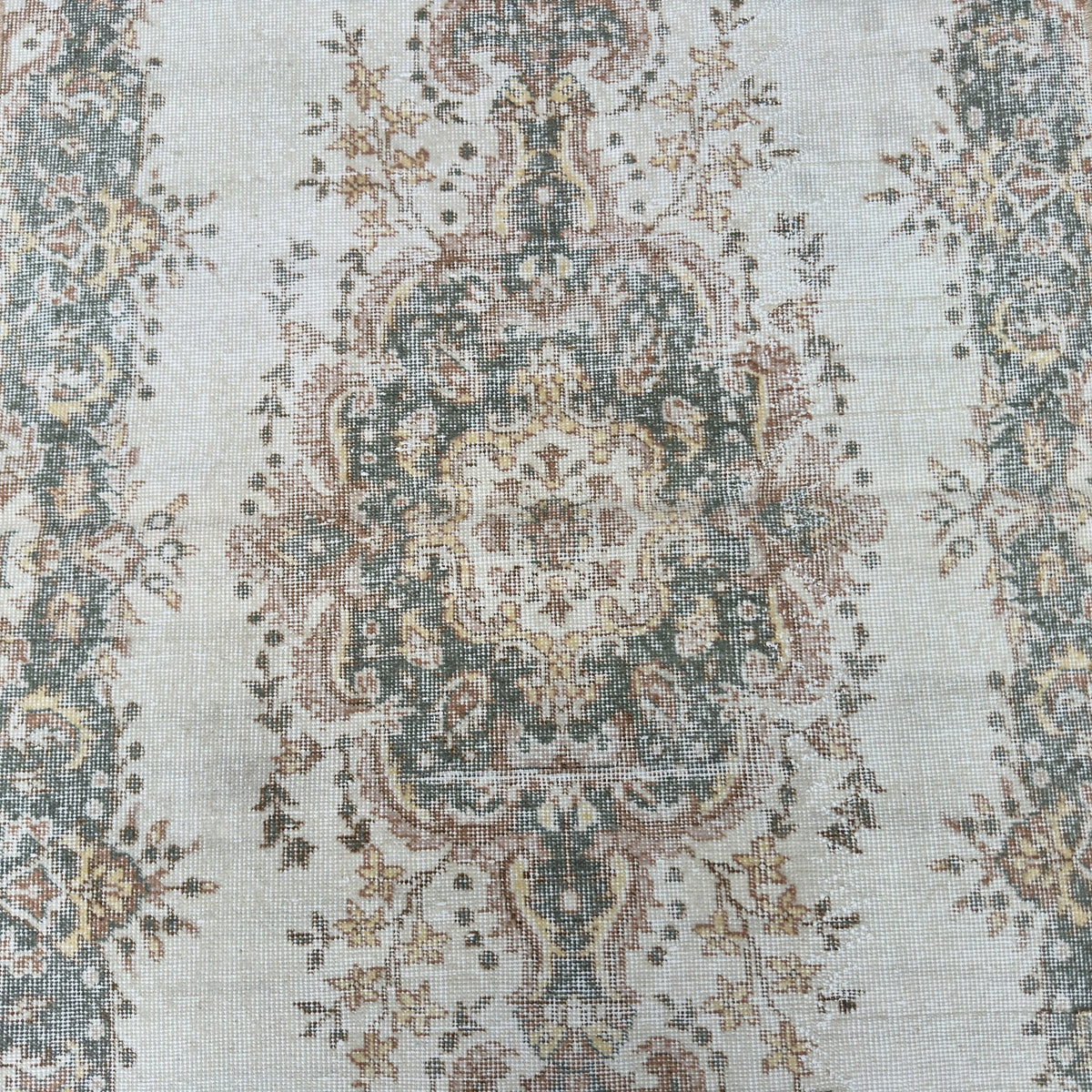 1970s pale green vintage Turkish geometric rug with medallion design, hand-knotted weave and low pile.