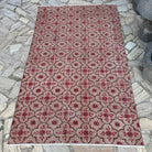 Red 4' x 7' vintage Turkish geometric rug in wool and cotton, shown on the floor.