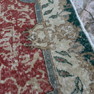 Close-up of the red vintage Turkish geometric rug showing traditional details, hand-knotted weave, wool and cotton and low pile.
