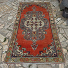 Orange 4' x 8' vintage Turkish geometric rug in wool and cotton, shown on the floor.