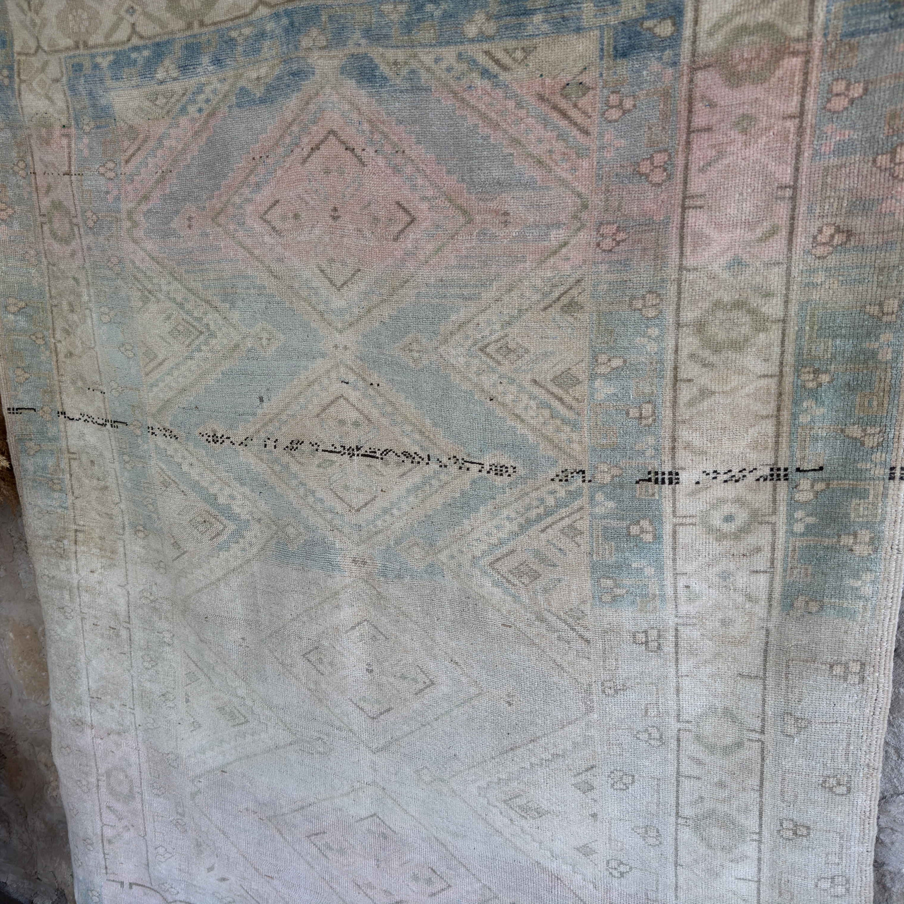 1970s pale blue vintage Turkish geometric rug with neutral design, hand-knotted weave and low pile.