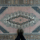 1970s pink vintage Turkish geometric rug with traditional design, hand-knotted weave and low pile.