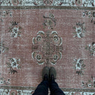 1970s pink vintage Turkish geometric rug with geometric design, hand-knotted weave and low pile.