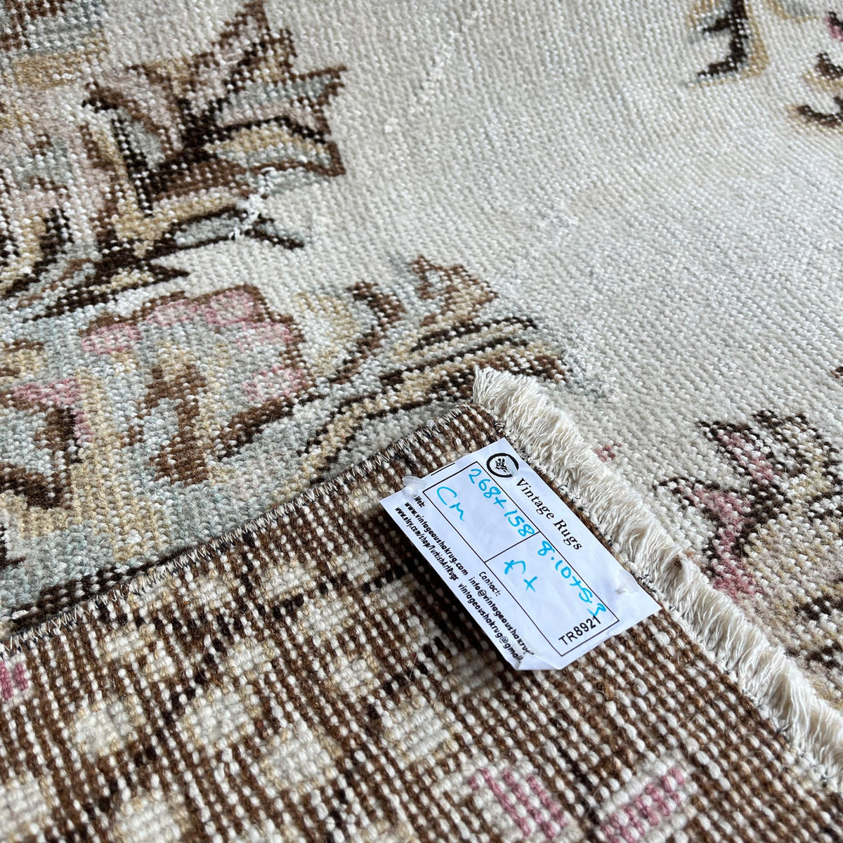 1970s pink vintage Turkish geometric rug with medallion design, hand-knotted weave and low pile.