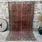 Red 5' x 9' vintage geometric rug with floral design, handmade in Turkey – Aron.