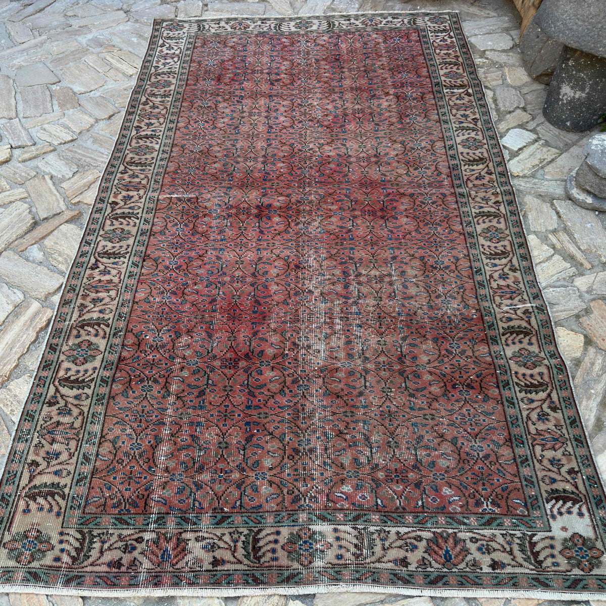 Red 5' x 9' vintage Turkish geometric rug in wool and cotton, shown on the floor.