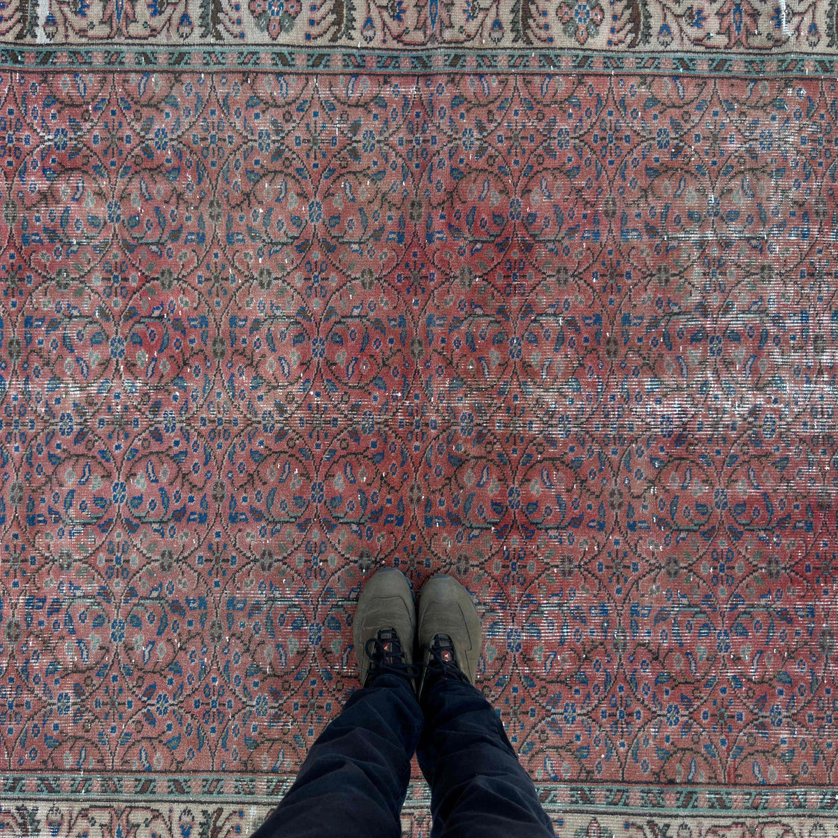1970s red vintage Turkish geometric rug with floral design, hand-knotted weave and low pile.