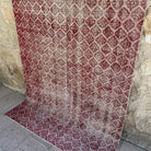 Red 5' x 9' vintage Turkish geometric rug in wool and cotton, shown on the floor.
