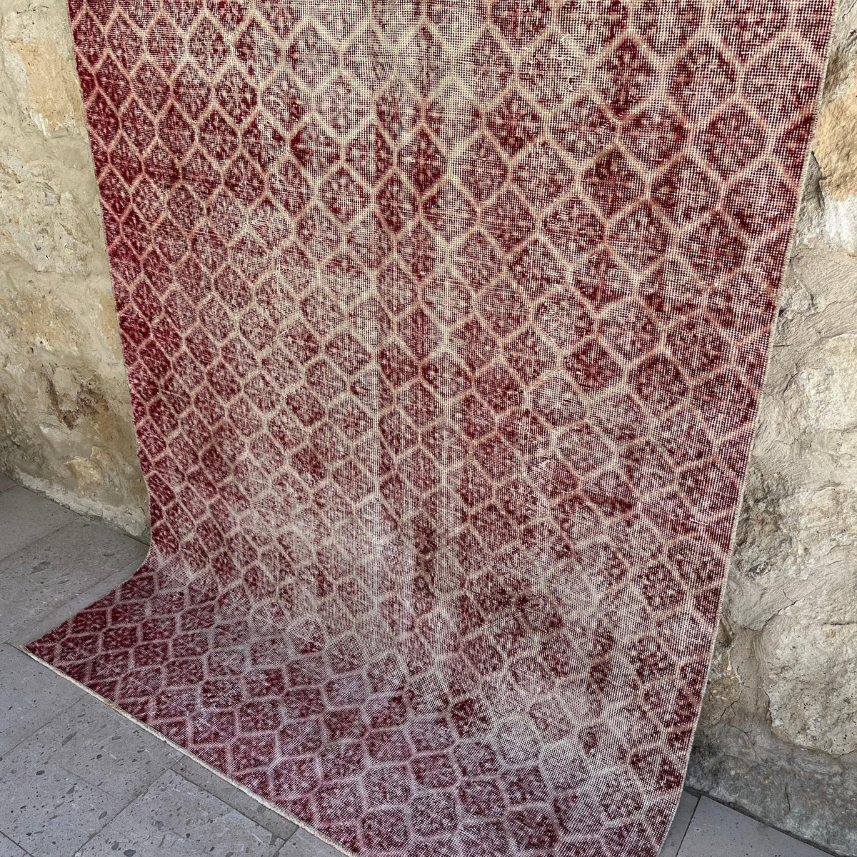 Red 5' x 9' vintage Turkish geometric rug in wool and cotton, shown on the floor.