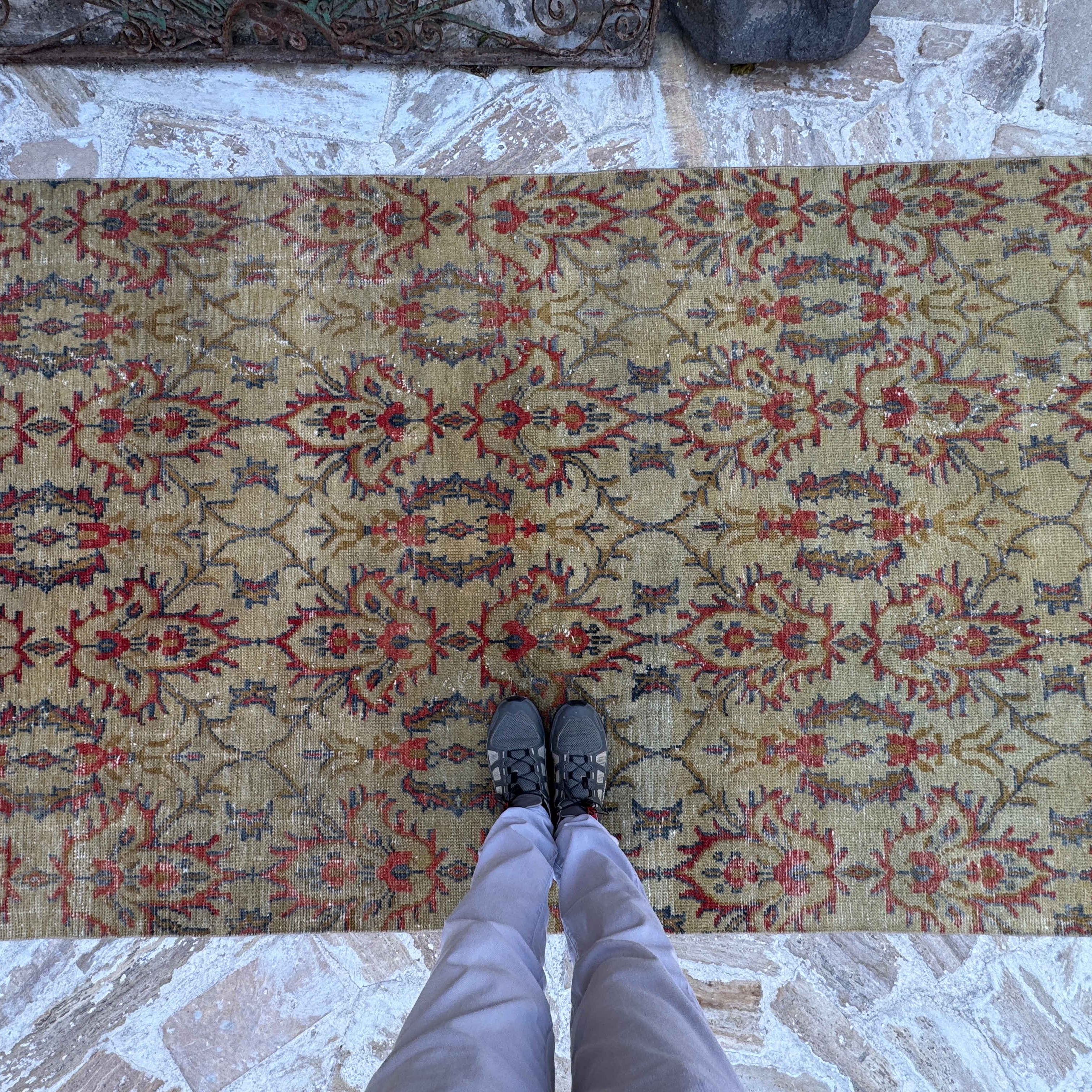 1970s yellow vintage Turkish geometric rug with floral design, hand-knotted weave and low pile.