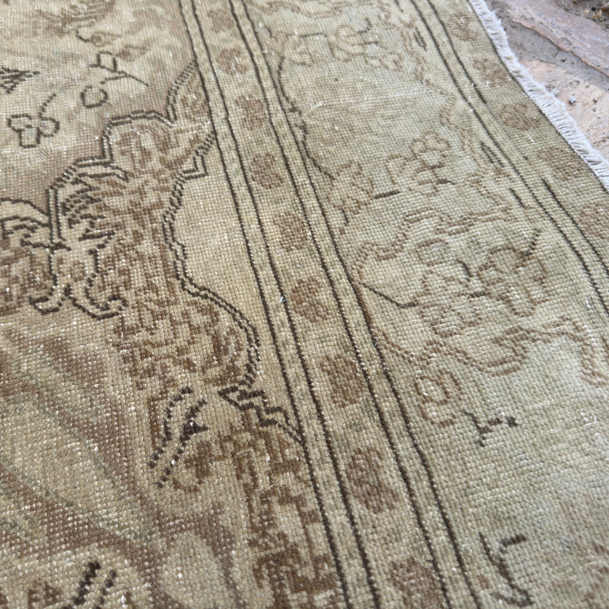 Close-up of the brown vintage Turkish geometric rug showing medallion details, hand-knotted weave, wool and cotton and low pile.