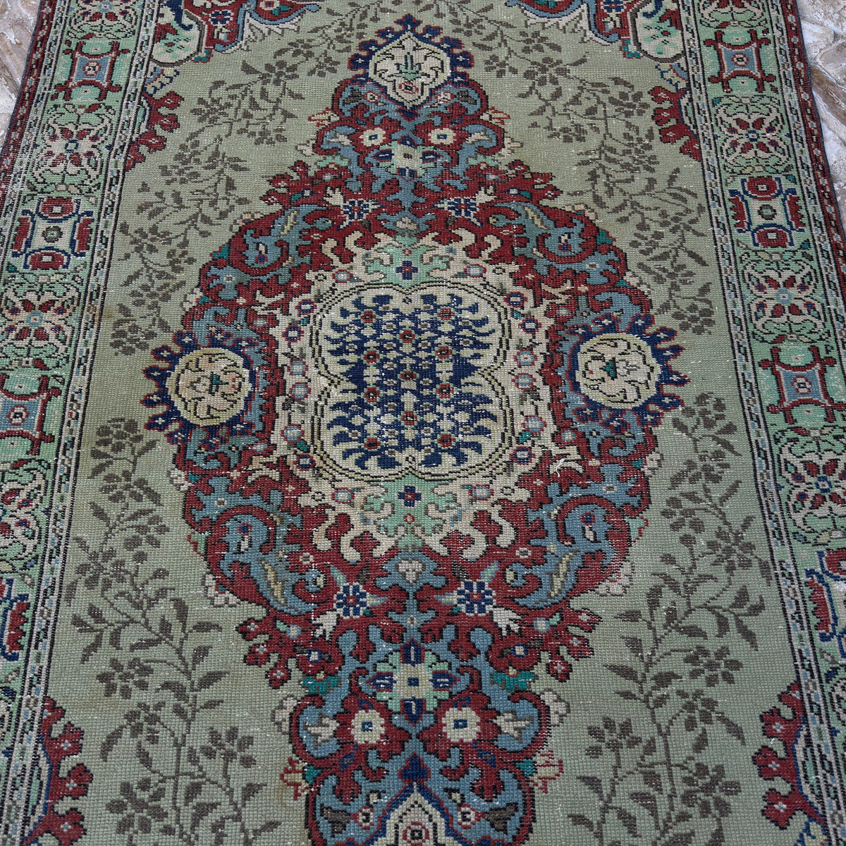 1970s green vintage Turkish geometric rug with medallion design, hand-knotted weave and low pile.