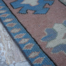 Beige 6' x 7' vintage Turkish geometric rug in wool, shown on the floor.