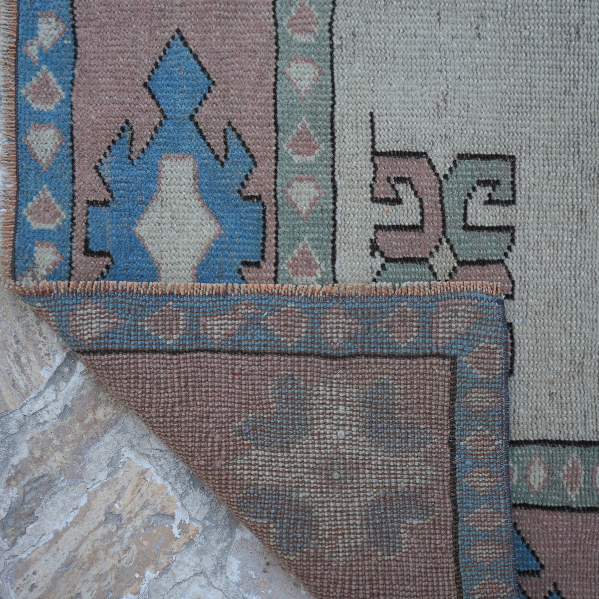 1970s beige vintage Turkish geometric rug with geometric design, hand-knotted weave and low pile.