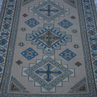 Close-up of the beige vintage Turkish geometric rug showing geometric details, hand-knotted weave, wool and low pile.