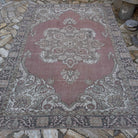 Pale Red 6' x 9' vintage Turkish geometric rug in wool and cotton, shown on the floor.