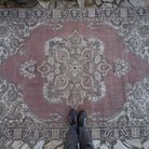 1970s pale red vintage Turkish geometric rug with medallion design, hand-knotted weave and low pile.