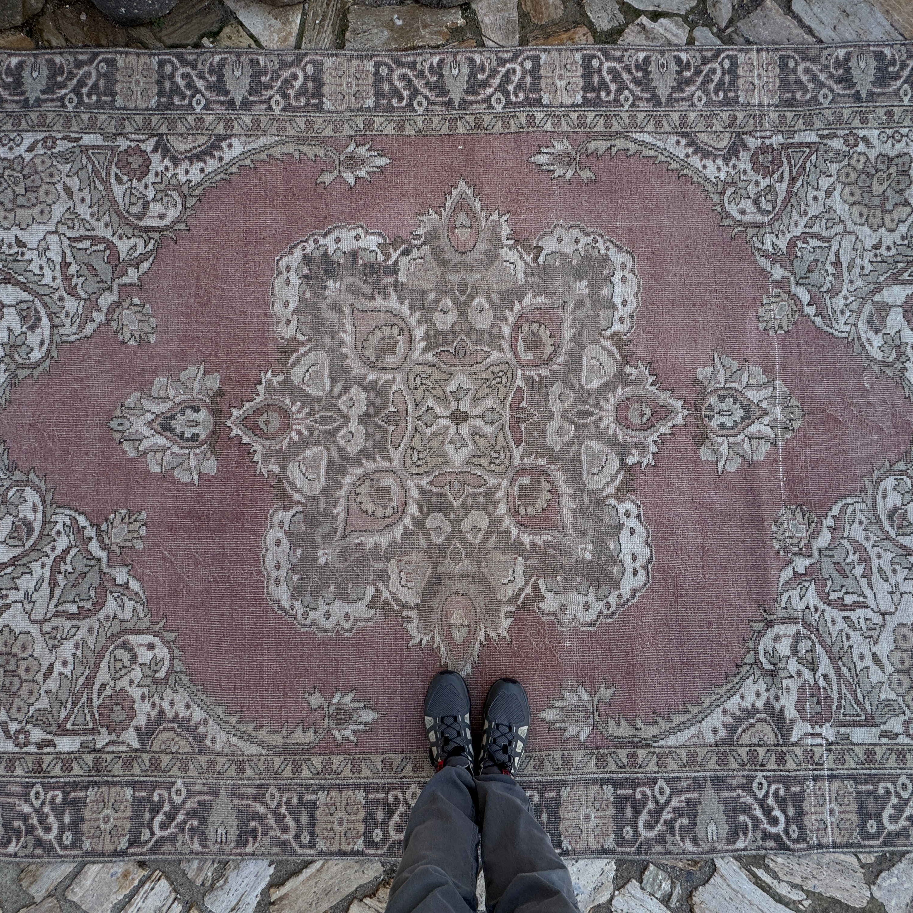 1970s pale red vintage Turkish geometric rug with medallion design, hand-knotted weave and low pile.