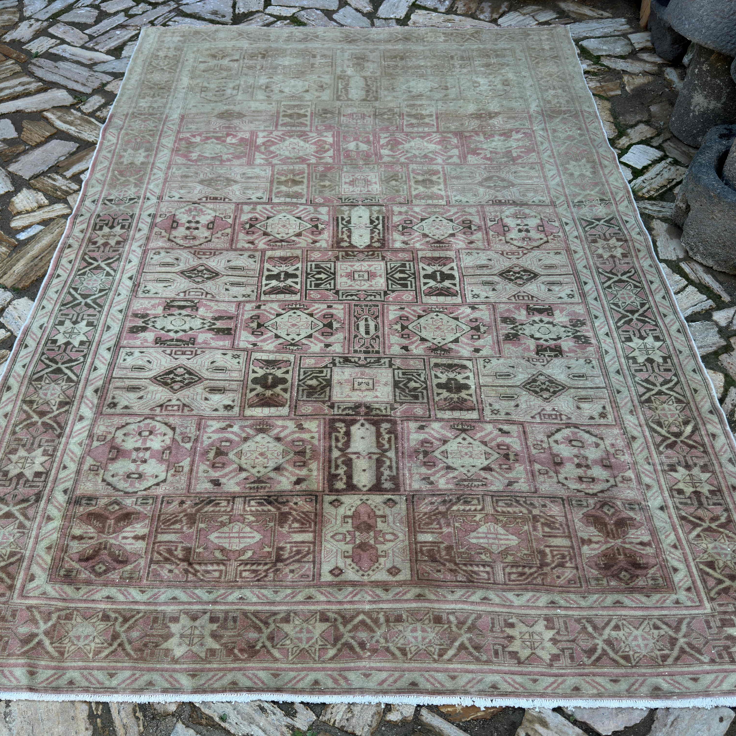 Pink 6' x 9' vintage Turkish geometric rug in wool and cotton, shown on the floor.