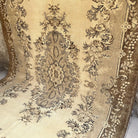 Brown 7' x 11' vintage Turkish geometric rug in wool and cotton, shown on the floor.