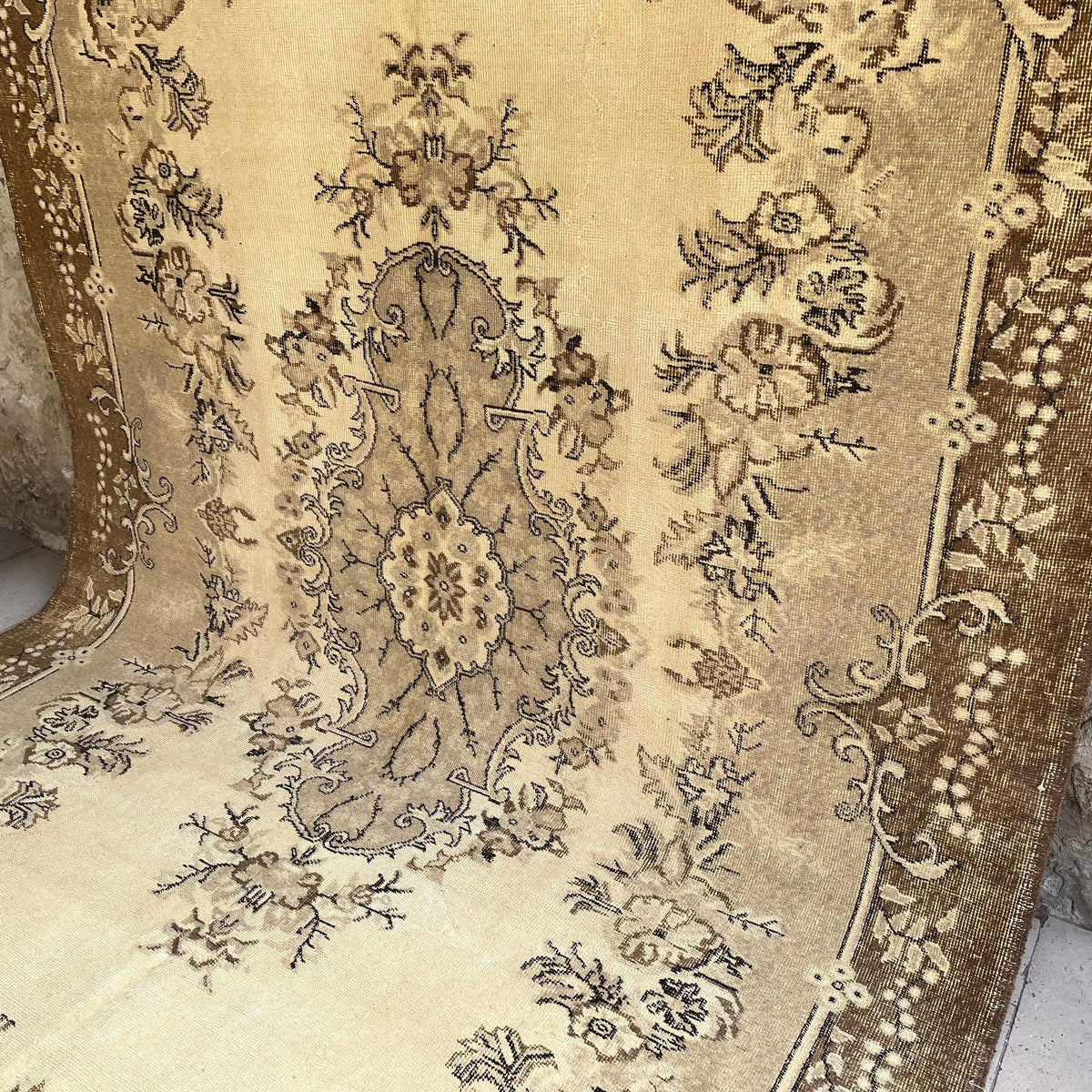 Brown 7' x 11' vintage Turkish geometric rug in wool and cotton, shown on the floor.